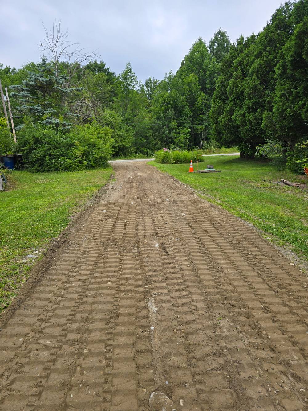 Graded gravel driveway with culvert marker, DeMillo's Excavation