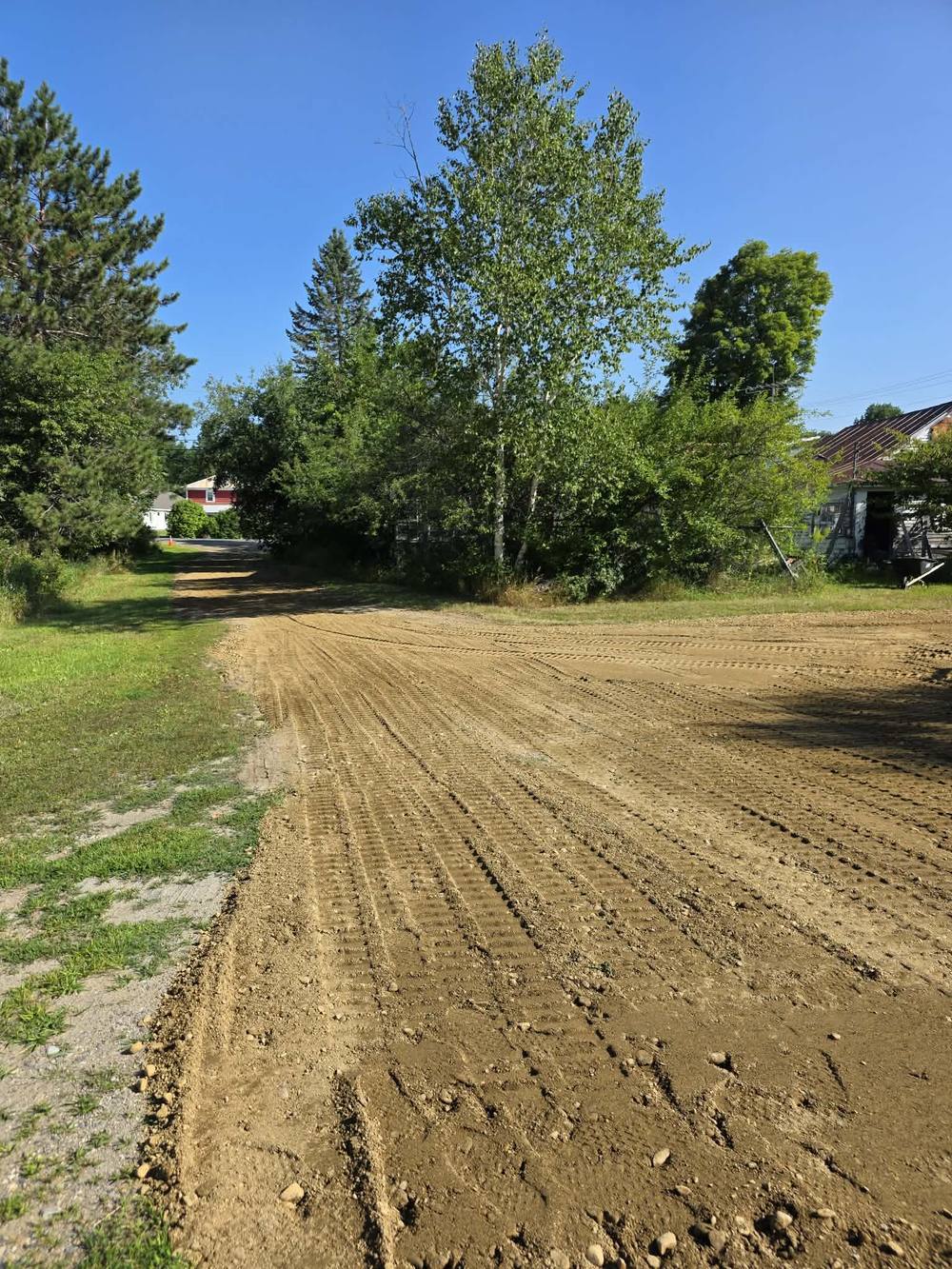 Long residential driveway regraded through wooded property