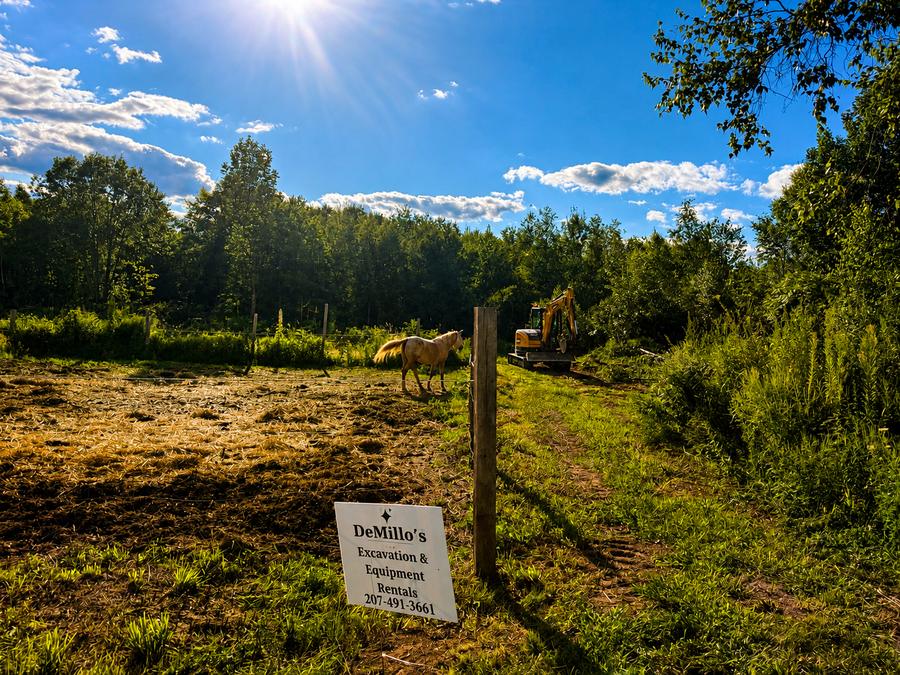 DeMillo's Excavation sign posted at a horse pasture land clearing job
